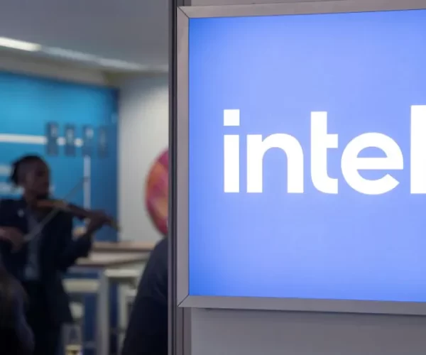 Intel lowers its full-year profit forecast and plans layoffs as the company ramps its sales into data centers.